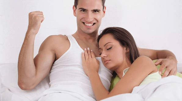 a woman in bed with a man who has increased potency